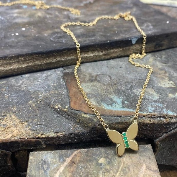 The JJ butterfly by Paulina jewelry made by hand in solid gold and emeralds