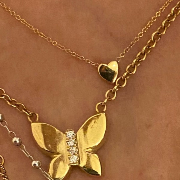 The JJ butterfly necklace in solid 18K and diamonds and the Heart necklace in solid 18K gold by Paulina jewelry