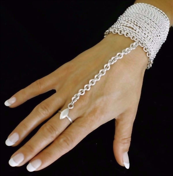 The VERO Ring bracelet is one of Paulina's signature pieces. This exotic one piece bracelet is made by hand in solid sterling silver and Italian sterling silver chains. Made by hand and to order in USA. www.paulinajewelry.com