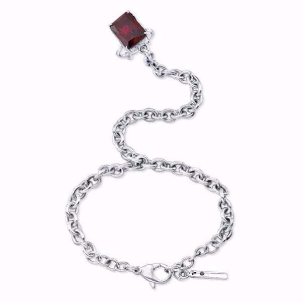 The Nini ring bracelet is made by hand in solid sterling silver, Italian solid sterling silver chains and a Garnet stone. Also available with other stones. The solid silver tag as a signature black diamond. Made by hand and to order in USA. Free shipping on all domestic orders. www.paulinajewelry.com