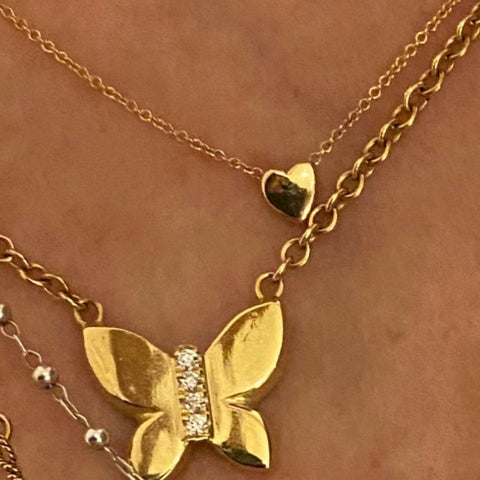 The JJ butterfly necklace in solid 18K and diamonds and the Heart necklace in solid 18K gold by Paulina jewelry